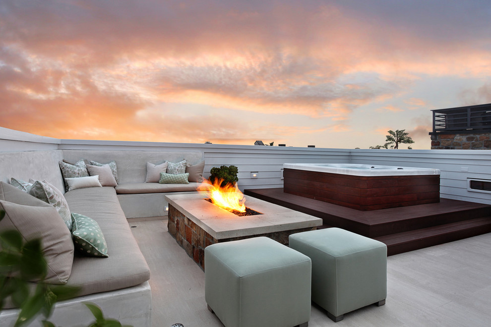 Example of a trendy deck design in Orange County with a fire pit