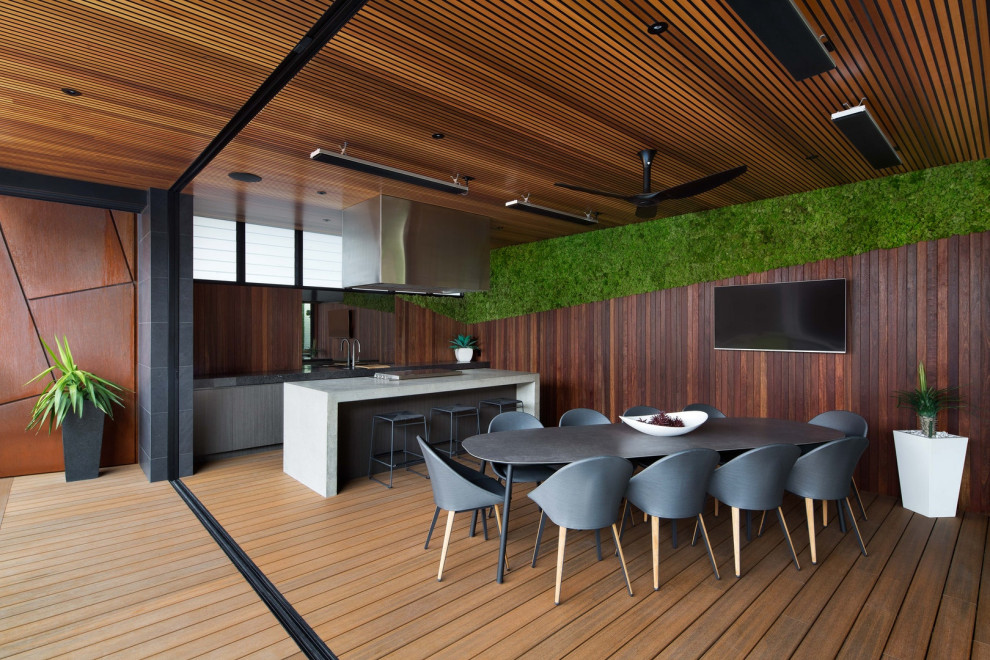 Trendy outdoor kitchen deck photo in Melbourne with a roof extension