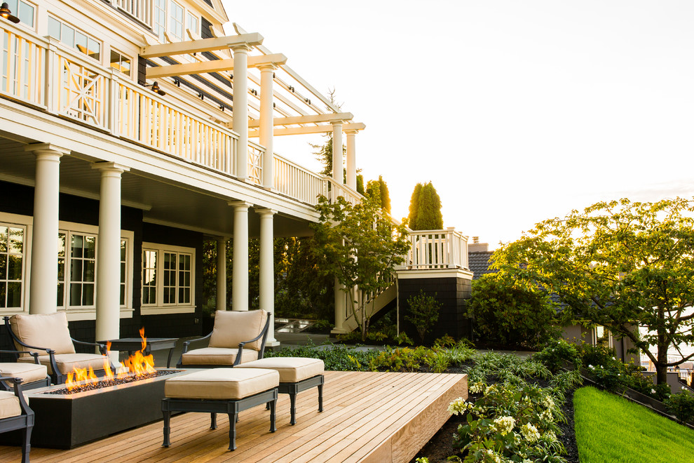 Deck - large contemporary backyard deck idea in Seattle with a fire pit