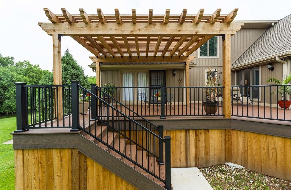 Inspiration for a large timeless backyard deck container garden remodel in Kansas City with a pergola