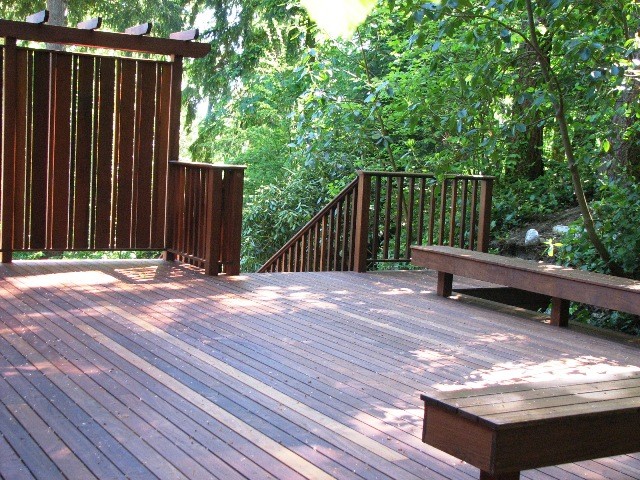 Example of an arts and crafts backyard deck design in Seattle with a pergola