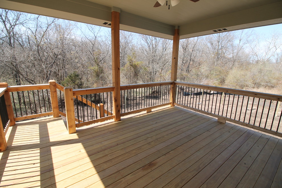Inspiration for a mid-sized country backyard deck remodel in Kansas City with a roof extension