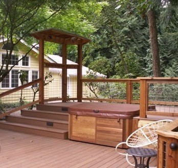 Inspiration for a large asian backyard deck remodel in Seattle with an awning