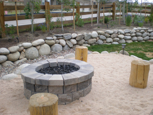Example of a large classic backyard deck design in Denver with a fire pit and no cover