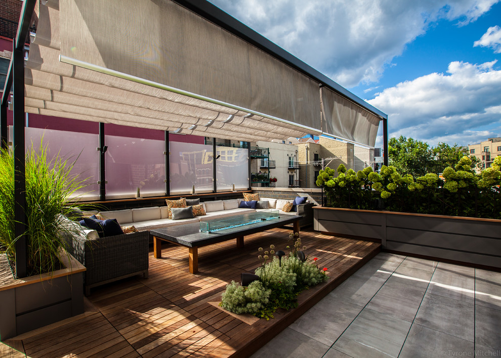 Design ideas for a medium sized contemporary roof terrace in Chicago with an outdoor kitchen and an awning.