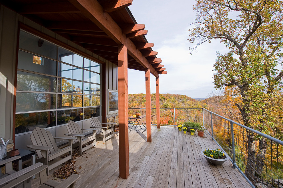Example of a large trendy rooftop deck design in Other with a roof extension