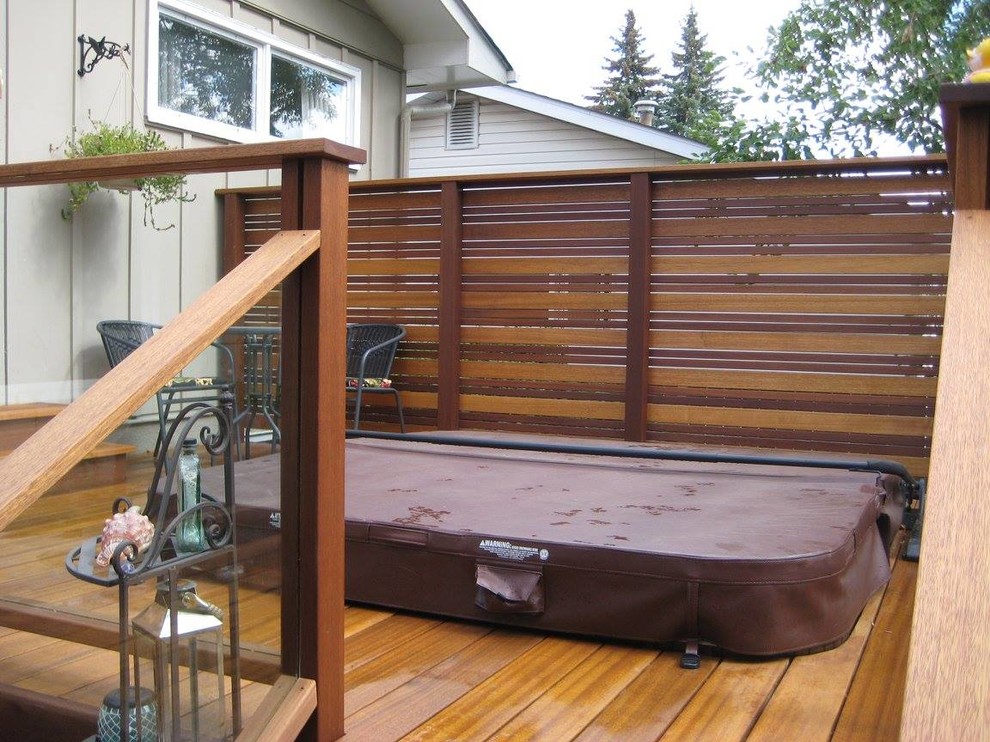 Water fountain deck - traditional backyard water fountain deck idea in Calgary with no cover