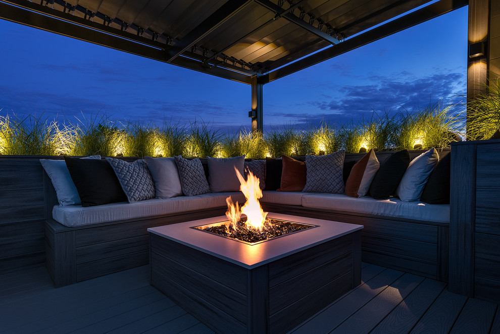 Expansive modern roof terrace in Chicago with a fireplace and a pergola.