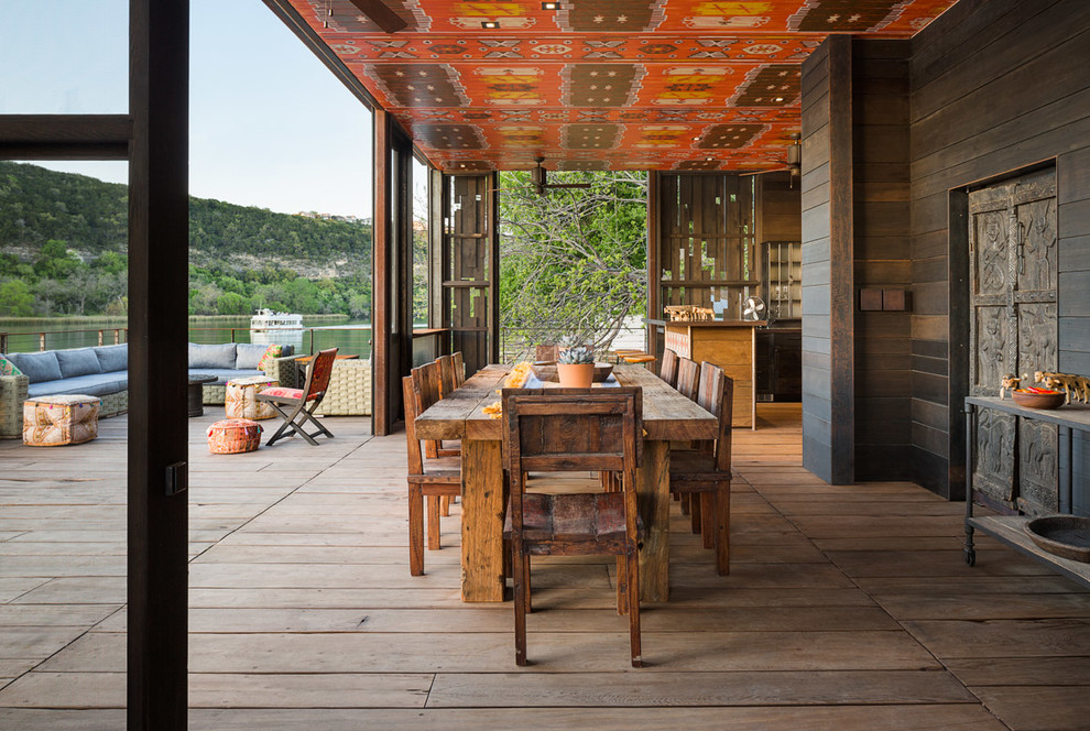 Inspiration for a rustic deck remodel in Austin with a roof extension