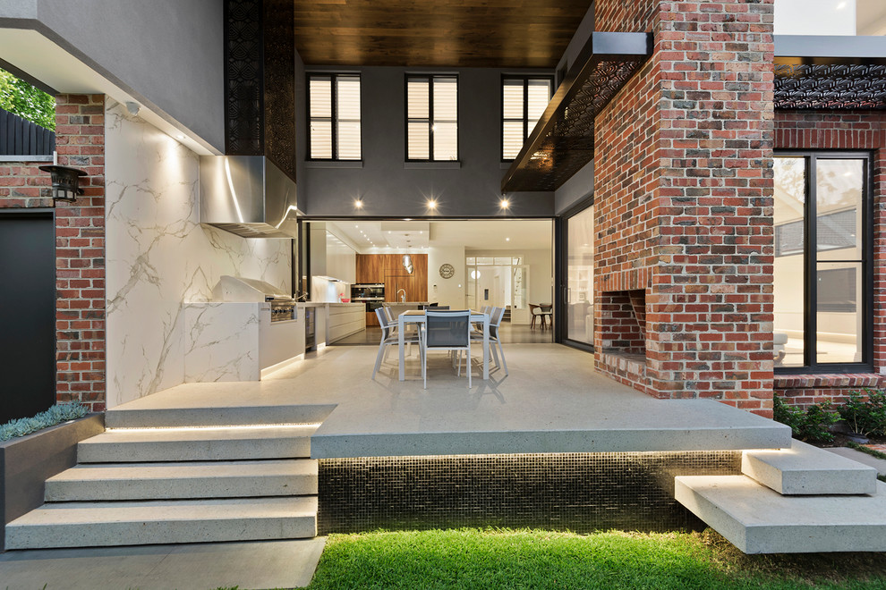 Photo of a large contemporary back terrace in Melbourne with an outdoor kitchen and a roof extension.