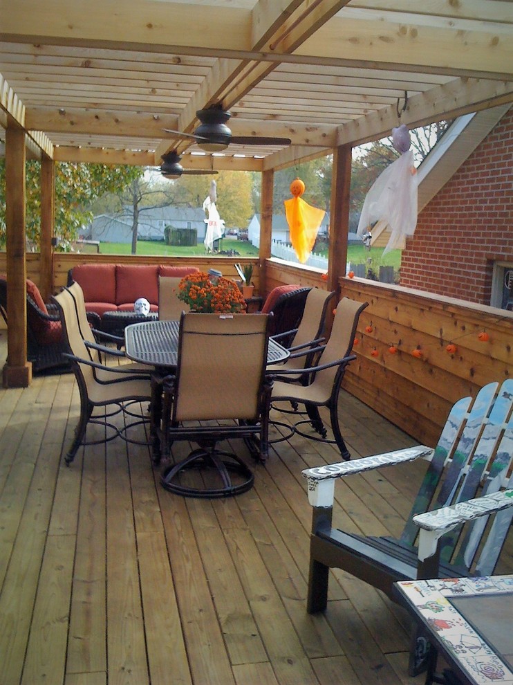 This is an example of a medium sized traditional side terrace in St Louis with a pergola.