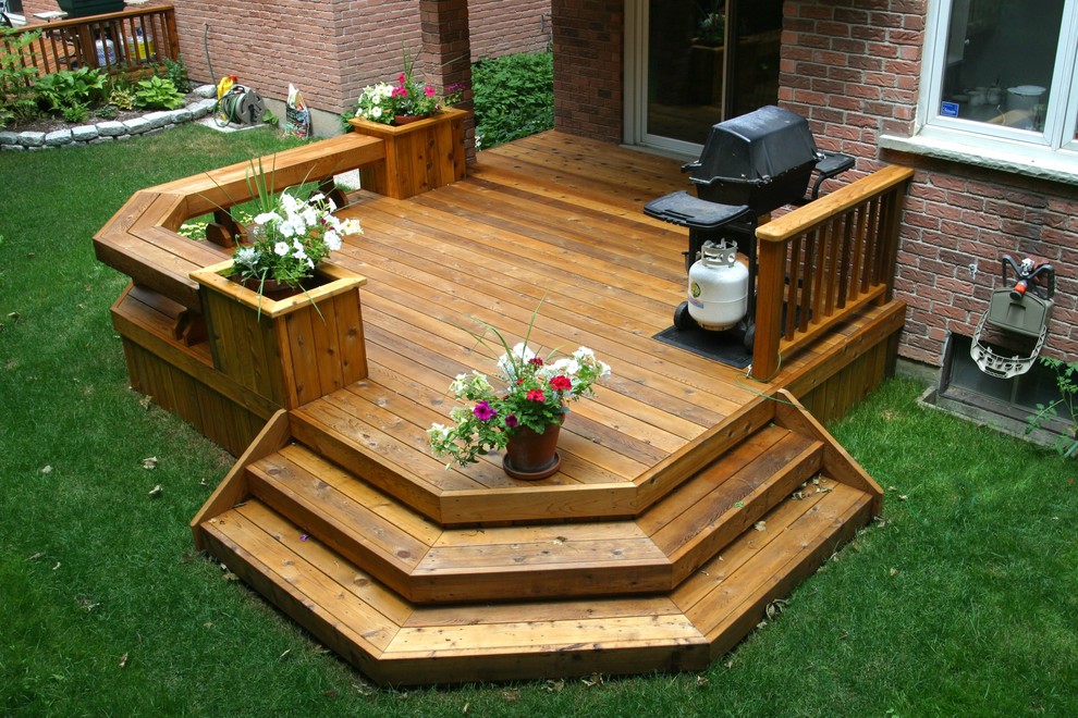 This is an example of a medium sized modern back terrace in Toronto.