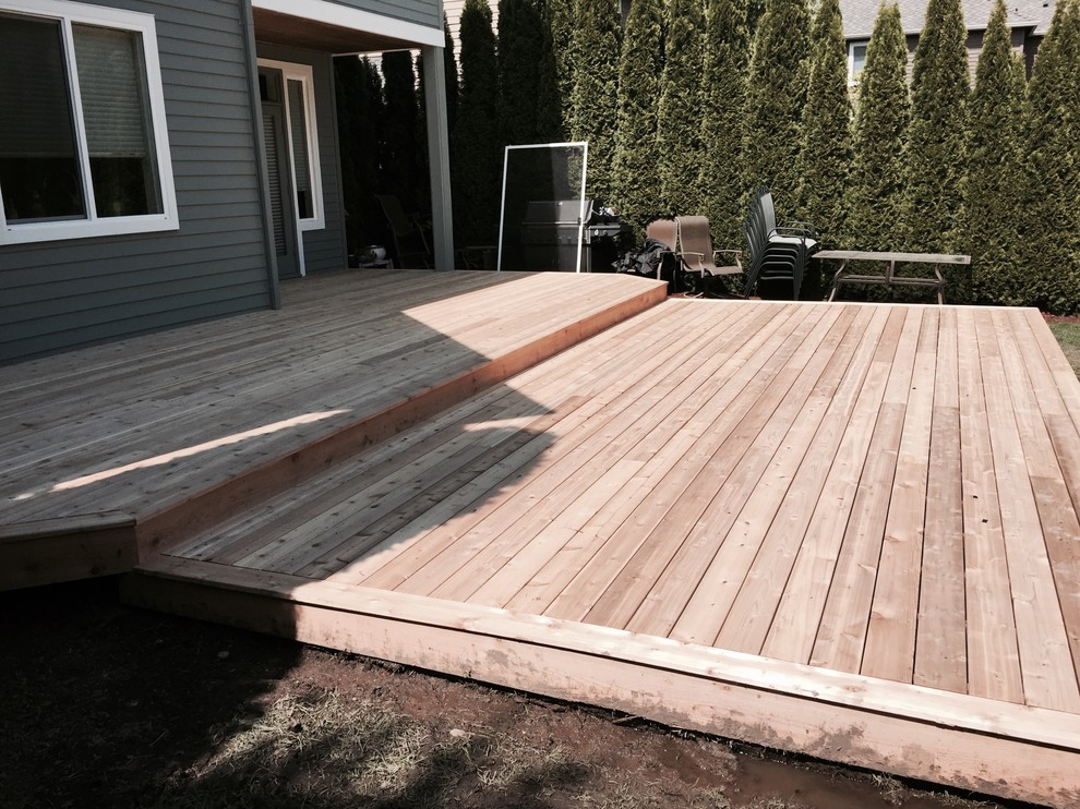 Example of a mid-sized arts and crafts backyard deck design in Seattle with no cover