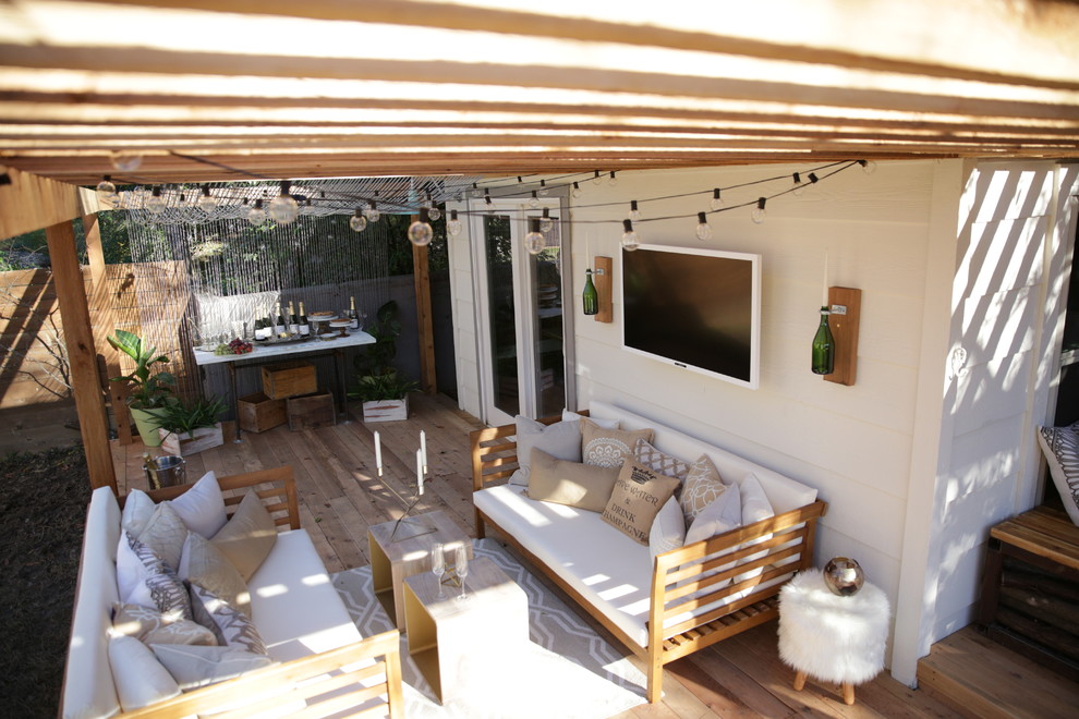 Inspiration for a small shabby-chic style backyard deck remodel in Austin with a pergola