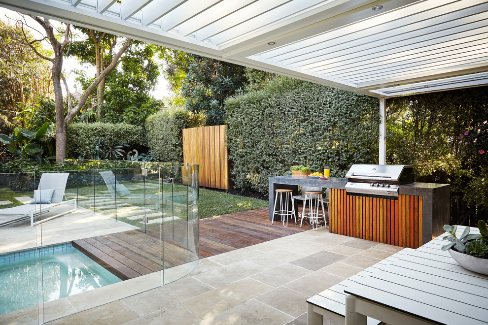 This is an example of a contemporary back terrace in Sydney with a pergola and a bbq area.