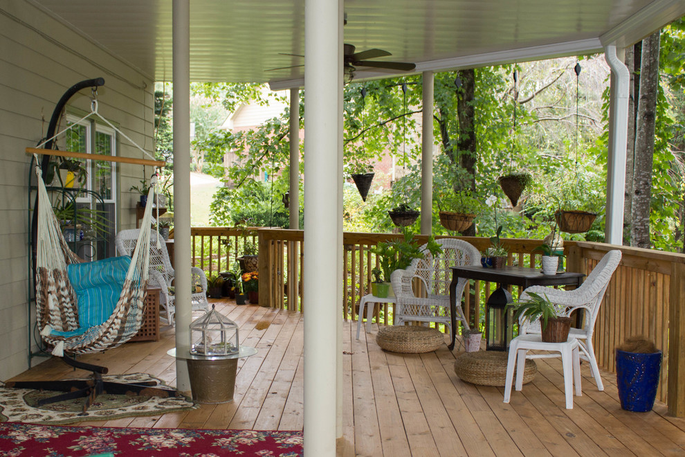 Example of a large classic backyard deck design in Atlanta with a roof extension