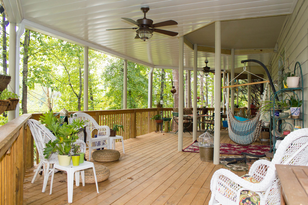 Inspiration for a large timeless backyard deck remodel in Atlanta with a roof extension