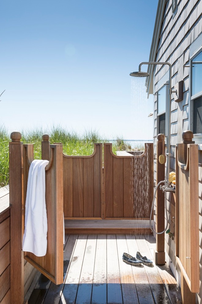 Example of a beach style outdoor shower deck design in Boston with no cover