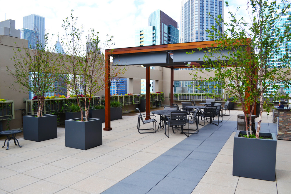 Example of a huge trendy rooftop outdoor kitchen deck design in Chicago with a pergola