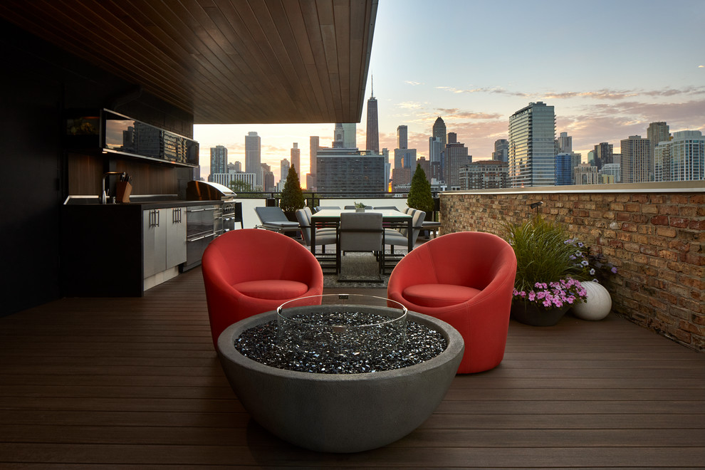 Mid-sized minimalist rooftop deck photo in Chicago with a fire pit and an awning