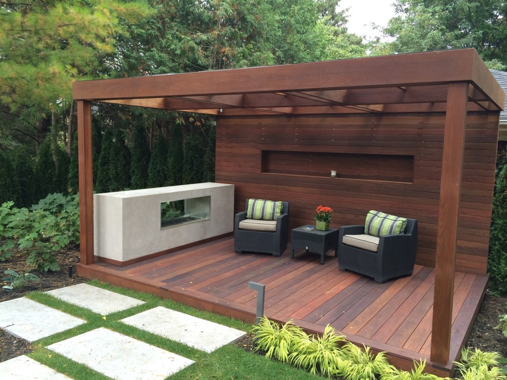 Inspiration for a mid-sized contemporary backyard deck remodel in Toronto with a pergola