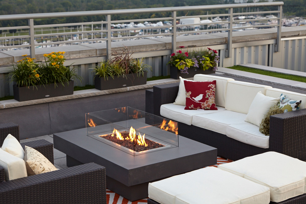 Large trendy rooftop deck photo in New York with a fire pit and no cover