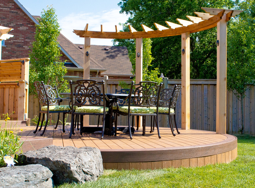 Large trendy backyard deck photo in Toronto with a pergola