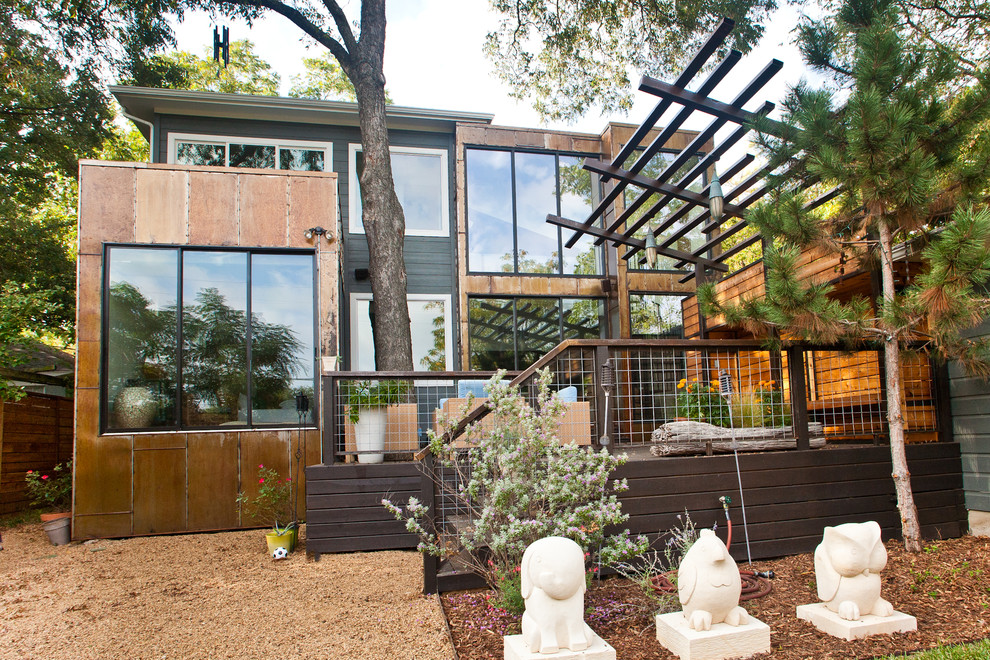 This is an example of a medium sized modern back terrace in Dallas with a pergola.