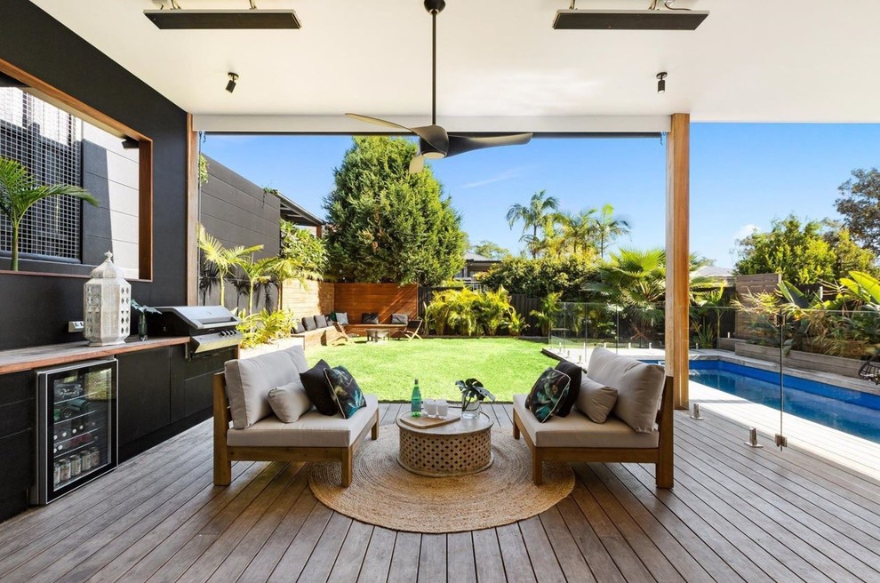 Contemporary back terrace in Sydney with a roof extension.