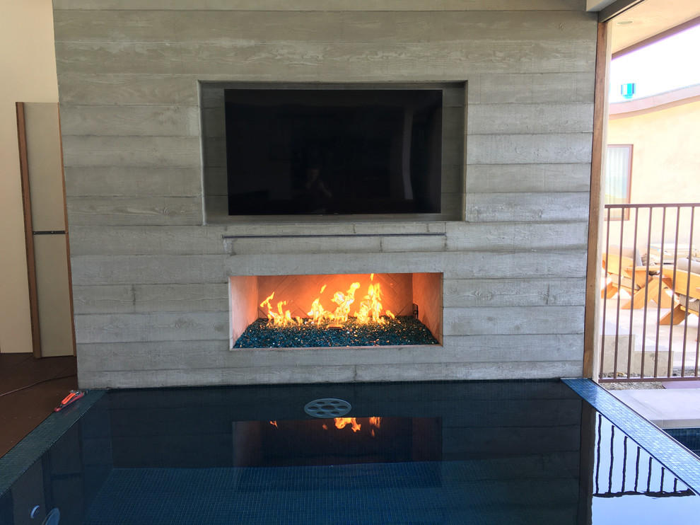 Medium sized contemporary back terrace in Orange County with a fire feature and a roof extension.