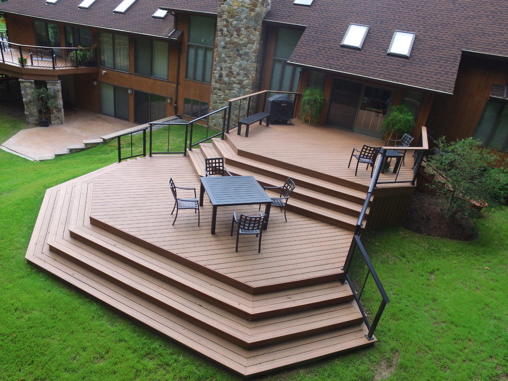 Example of a large minimalist backyard deck design in Philadelphia