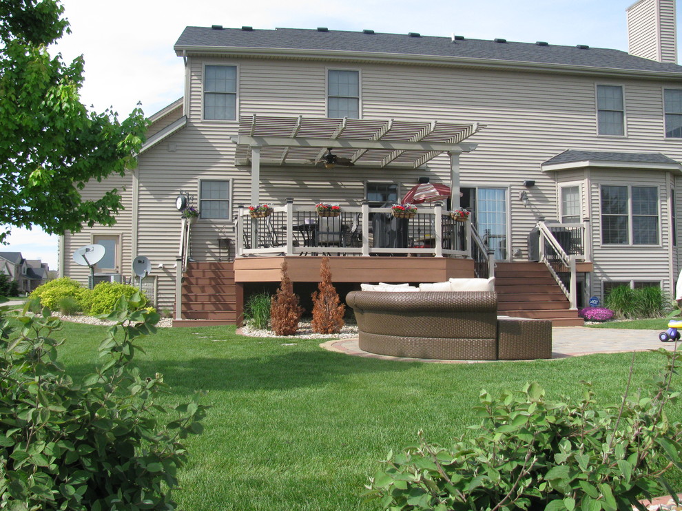 Inspiration for a backyard deck remodel in Chicago with a pergola