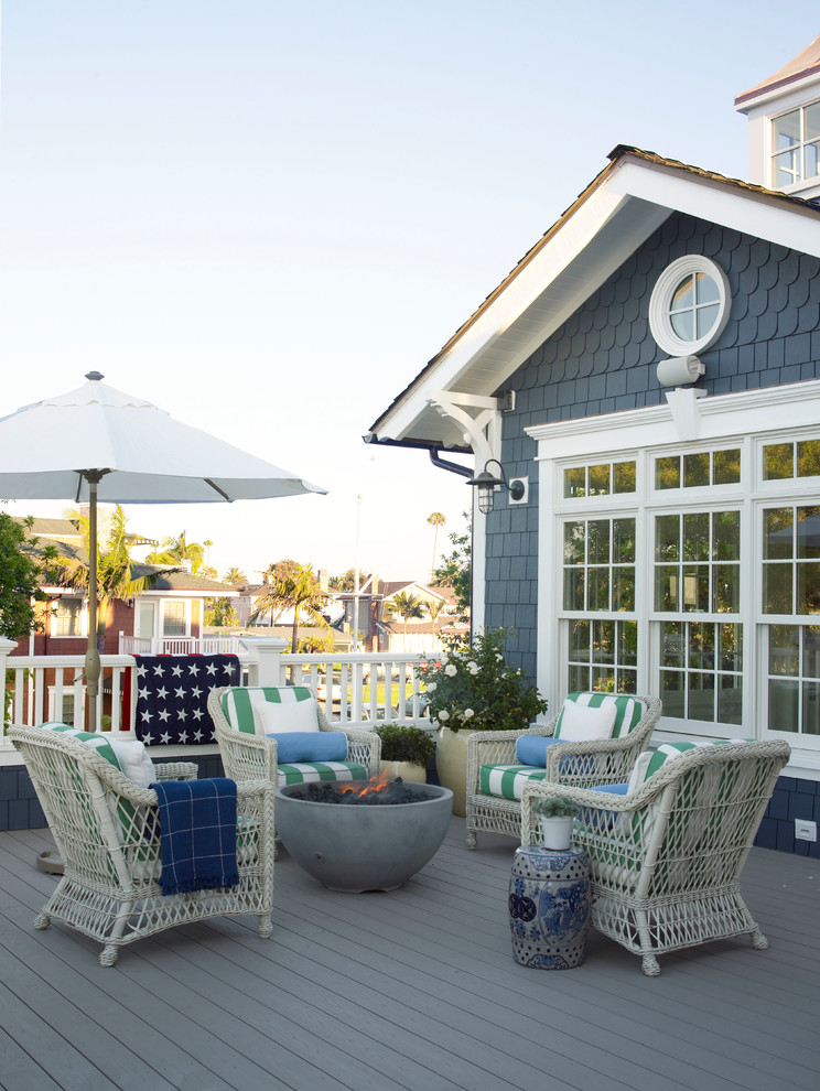 Inspiration for a small coastal deck remodel in San Diego with a fire pit