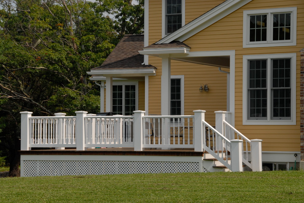 Example of a large country backyard deck design in Boston with no cover