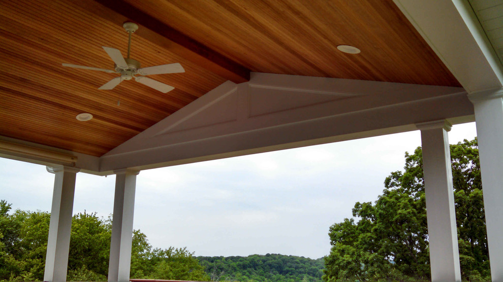 Exemple d'une terrasse arrière chic de taille moyenne avec une extension de toiture.