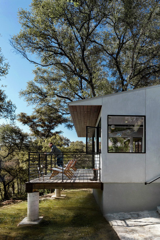 Inspiration for a contemporary deck remodel in Austin with a roof extension