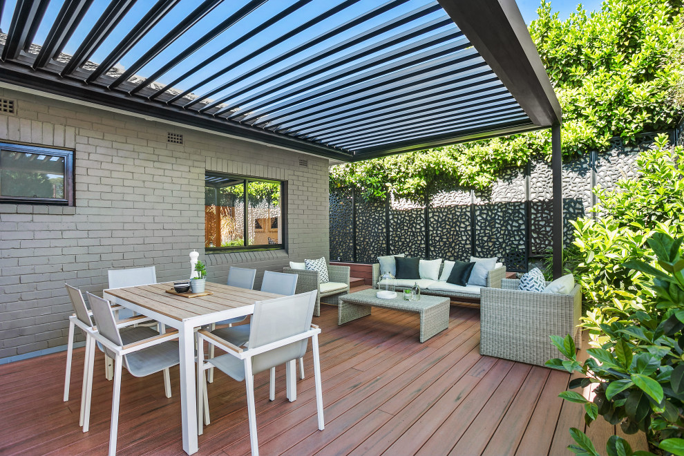 Photo of a large contemporary back terrace in Sydney with a pergola.