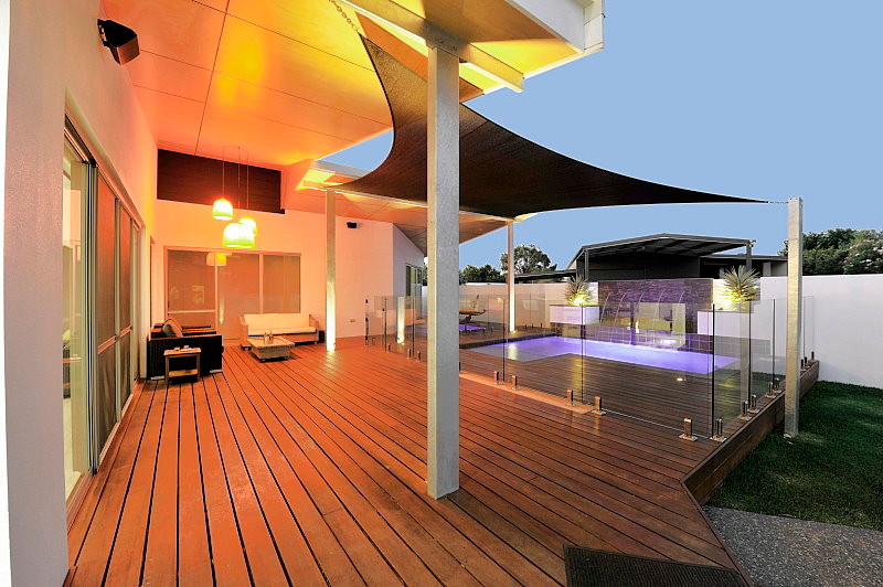 Inspiration for a large contemporary backyard deck remodel in Perth with a roof extension