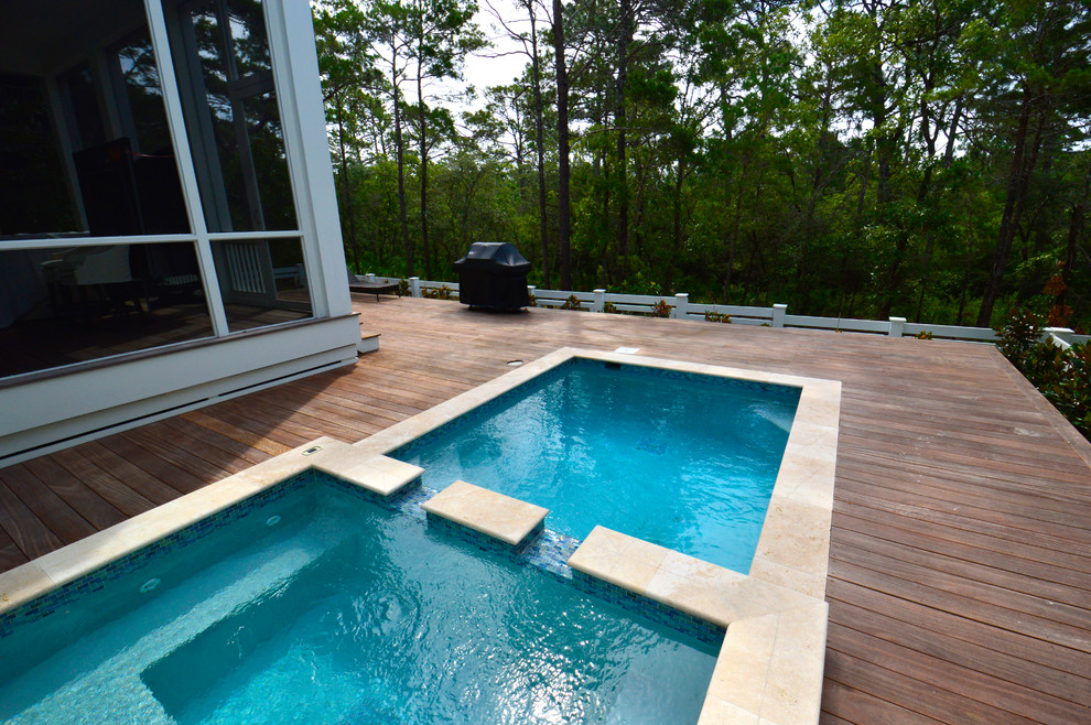 Example of a large beach style backyard pool design in Miami