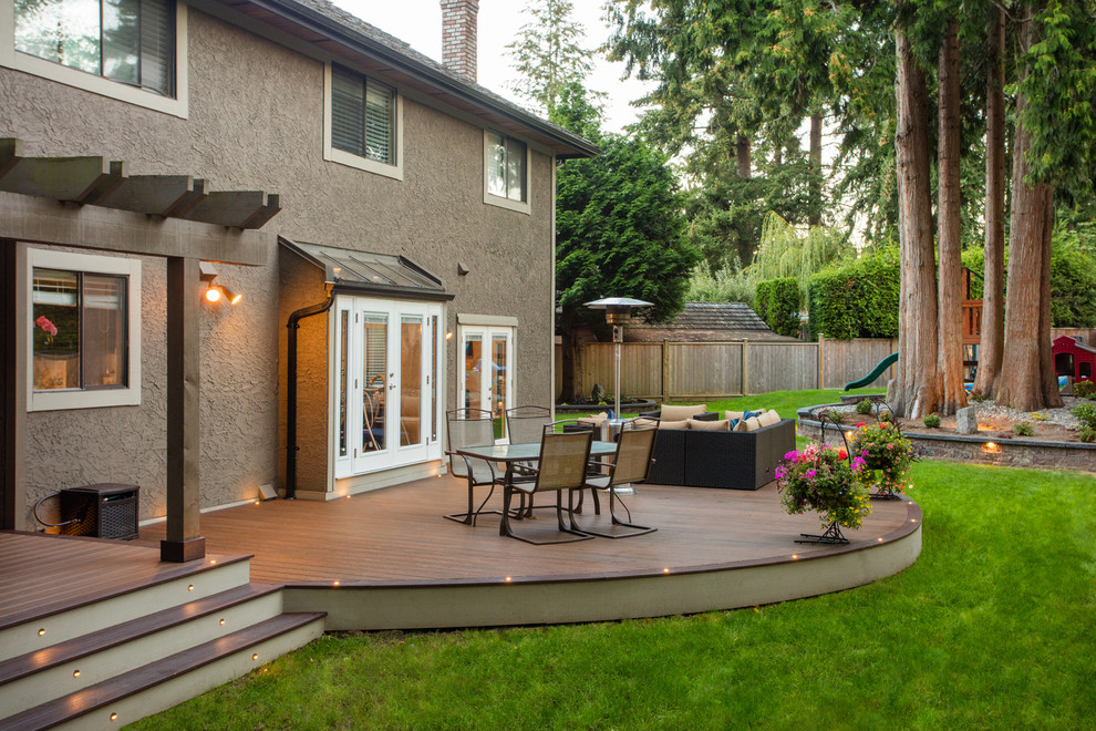 Photo of an expansive modern back terrace in Vancouver with a fire feature.