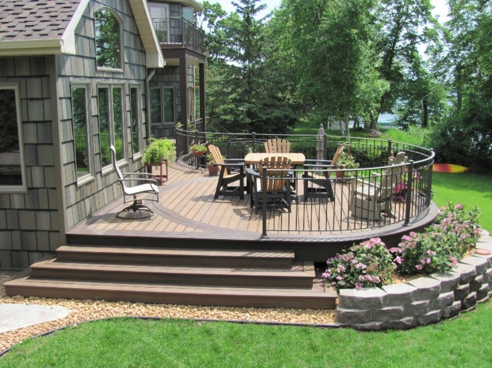 Example of a large backyard deck design in Minneapolis with no cover