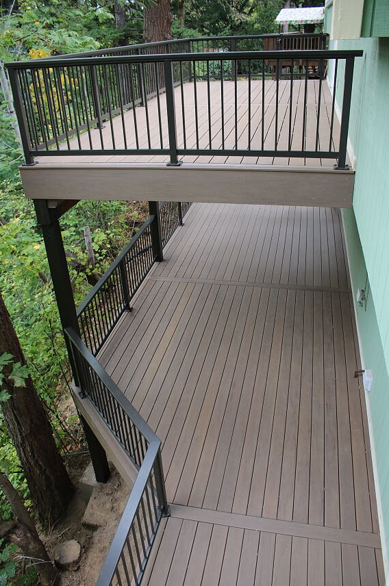Example of a large trendy backyard deck design in Portland with no cover