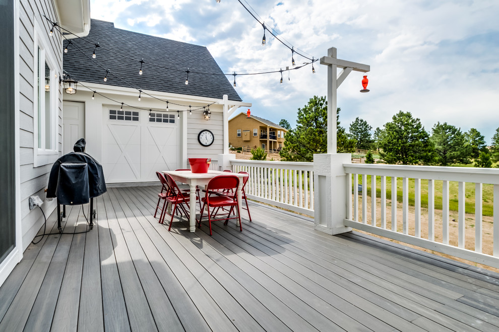 Example of a large farmhouse backyard deck design in Denver with no cover