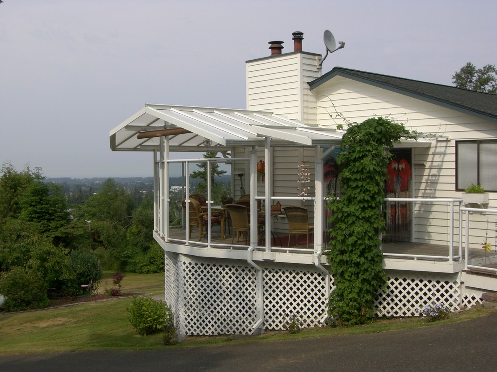 Diseño de terraza de estilo de casa de campo de tamaño medio en patio lateral con toldo