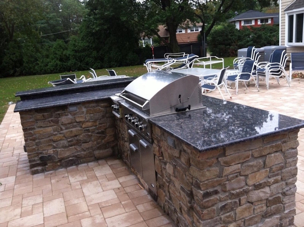 Example of a mid-sized transitional backyard outdoor kitchen deck design in New York with no cover