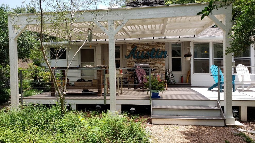 Large vintage back terrace in Austin with a pergola.