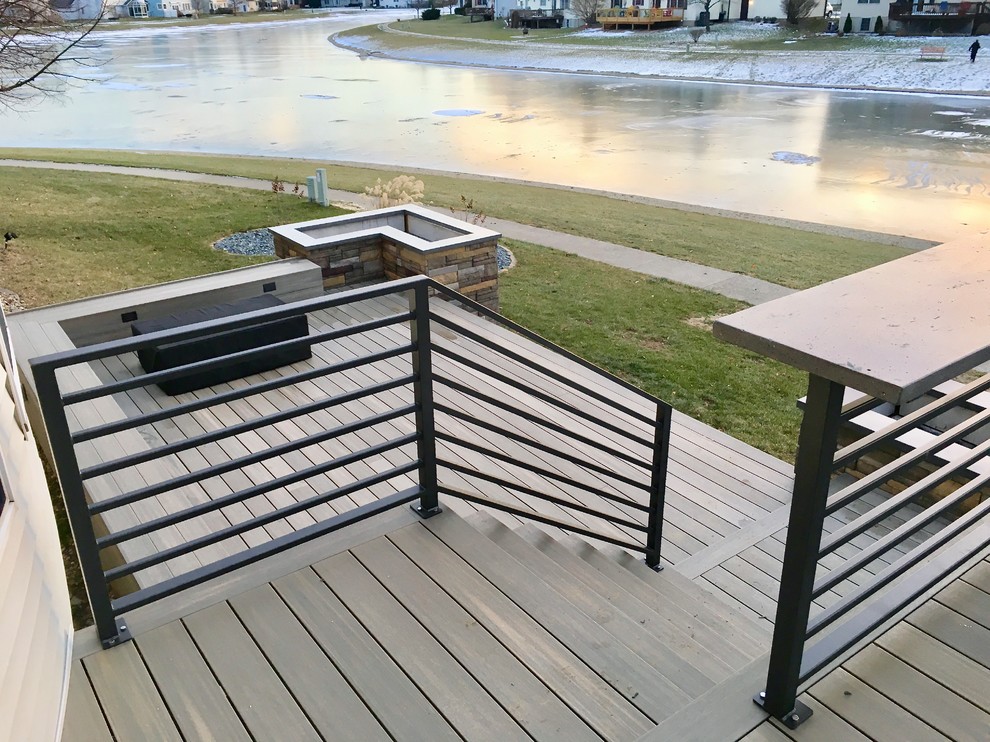 Huge minimalist backyard outdoor kitchen deck photo in Austin with a pergola