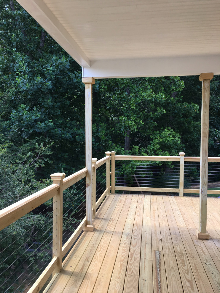 Large trendy backyard deck photo in Atlanta with a roof extension