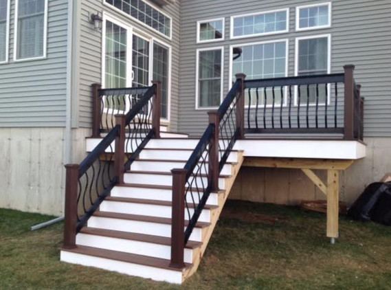 Dark brown Trex deck with contemporary metal railing - Contemporary ...