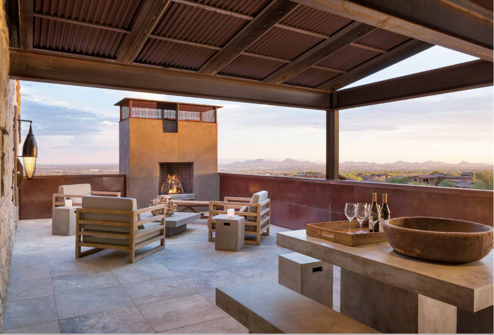 Inspiration for a southwestern deck remodel in Phoenix with a fire pit and a roof extension